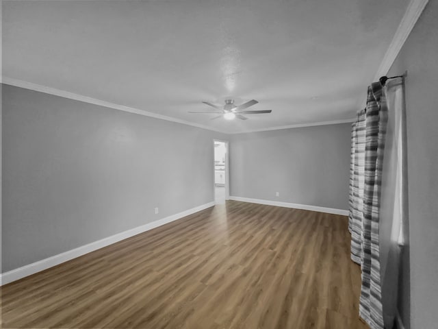 empty room with ornamental molding, hardwood / wood-style floors, and ceiling fan