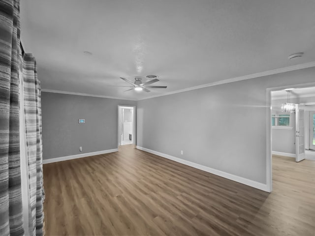 unfurnished living room featuring hardwood / wood-style floors, ceiling fan with notable chandelier, and ornamental molding