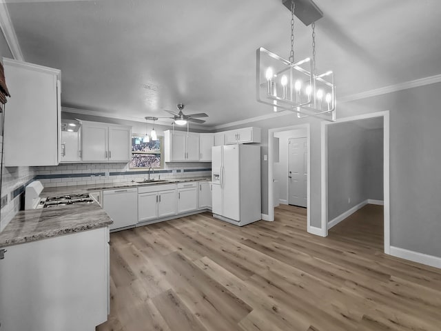 kitchen featuring ornamental molding, white cabinets, white appliances, and decorative light fixtures