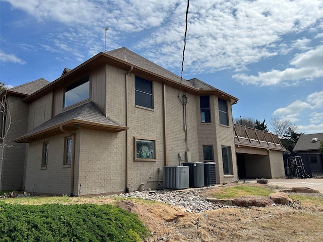 view of side of home with central air condition unit