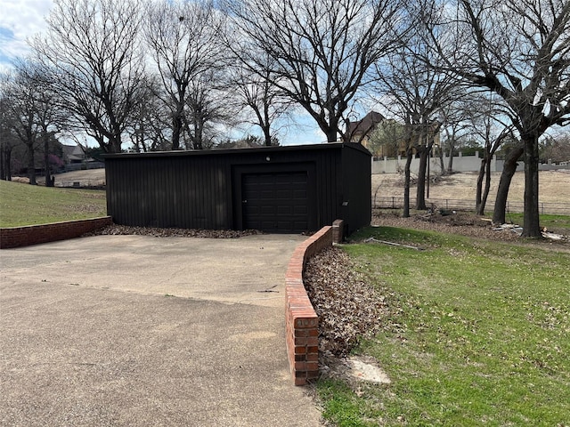 view of outbuilding with a garage and a yard