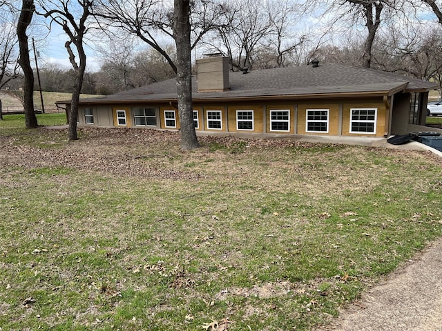 back of property featuring a yard