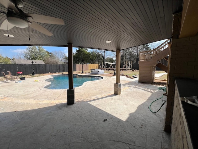 view of swimming pool with ceiling fan and a patio