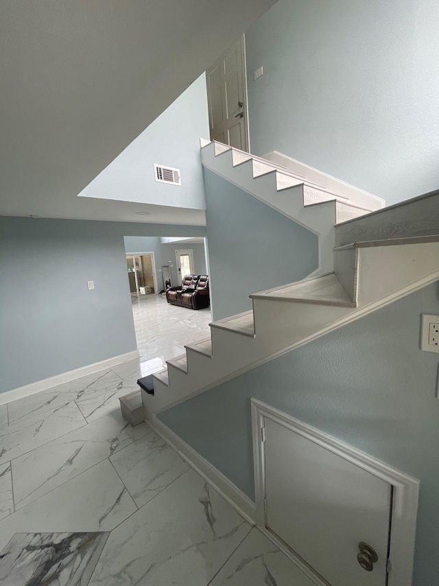 stairway featuring vaulted ceiling