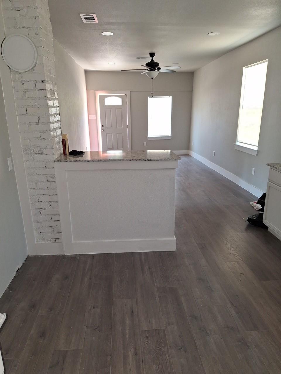 foyer with ceiling fan and dark hardwood / wood-style flooring