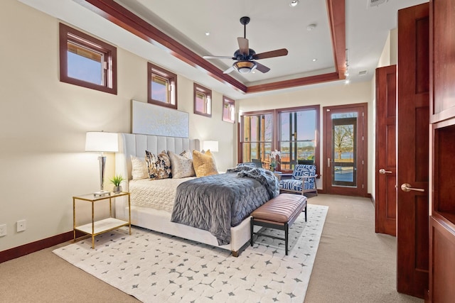 carpeted bedroom with a raised ceiling, access to outside, and ceiling fan