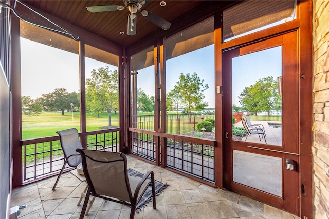 sunroom / solarium with wood ceiling and ceiling fan