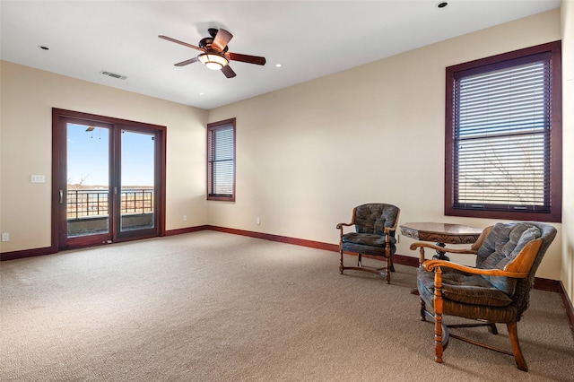 sitting room featuring carpet and ceiling fan