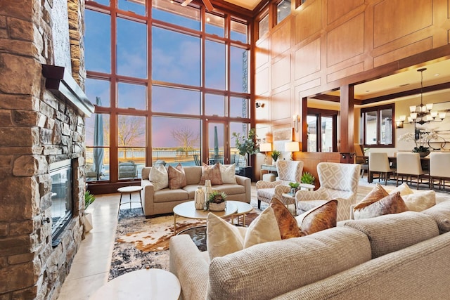 interior space with an inviting chandelier, a fireplace, and a high ceiling