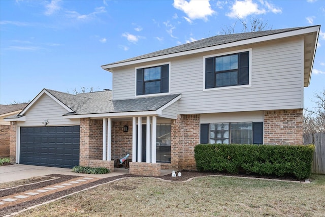 view of property featuring a garage and a front lawn