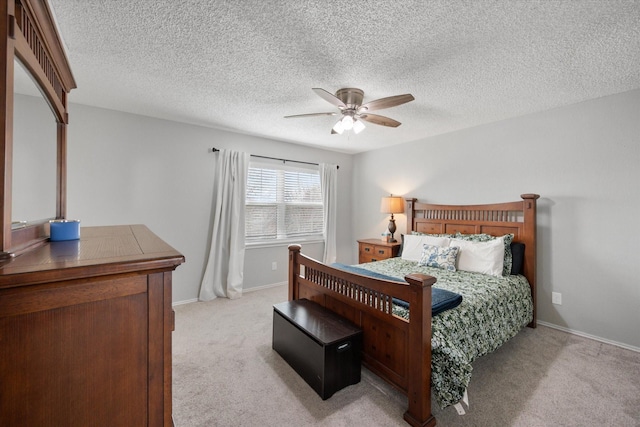 carpeted bedroom with a textured ceiling and ceiling fan