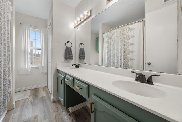 bathroom with hardwood / wood-style flooring and vanity