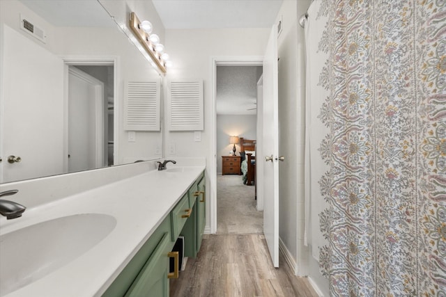 bathroom with vanity, wood-type flooring, and a shower with shower curtain