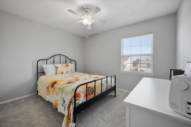 bedroom featuring ceiling fan, carpet, and a textured ceiling