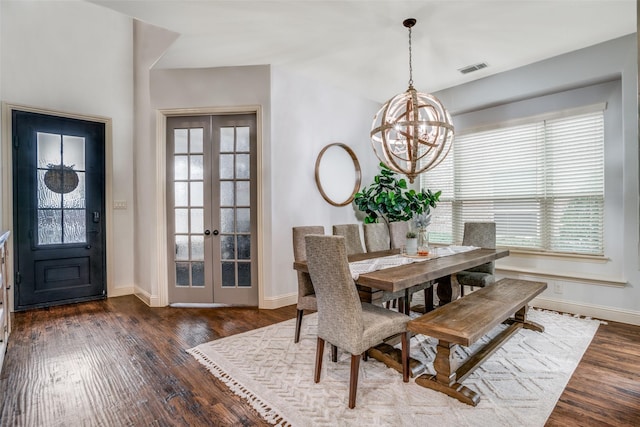 dining space with a notable chandelier, dark hardwood / wood-style floors, and french doors