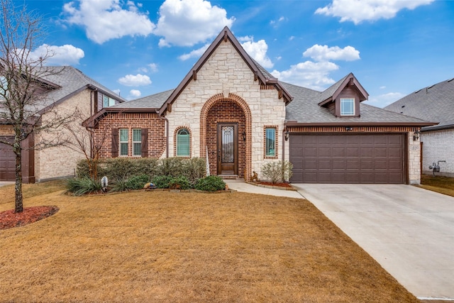 view of front of property featuring a garage and a front yard