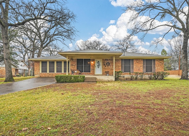 ranch-style house with a porch and a front yard