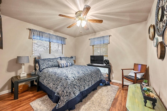 bedroom with ceiling fan and wood-type flooring