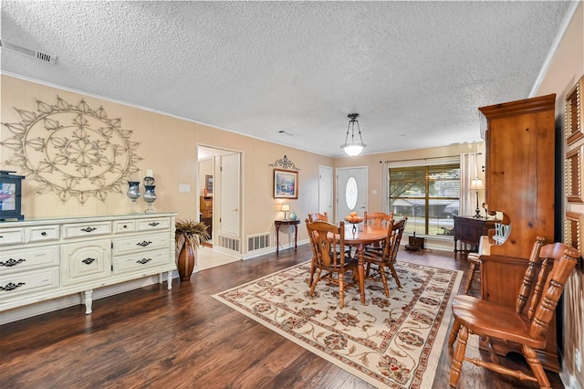 dining space with hardwood / wood-style flooring and a textured ceiling