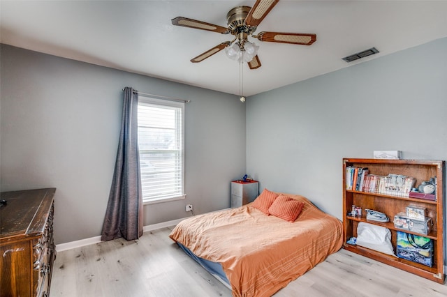 bedroom with light hardwood / wood-style flooring and ceiling fan