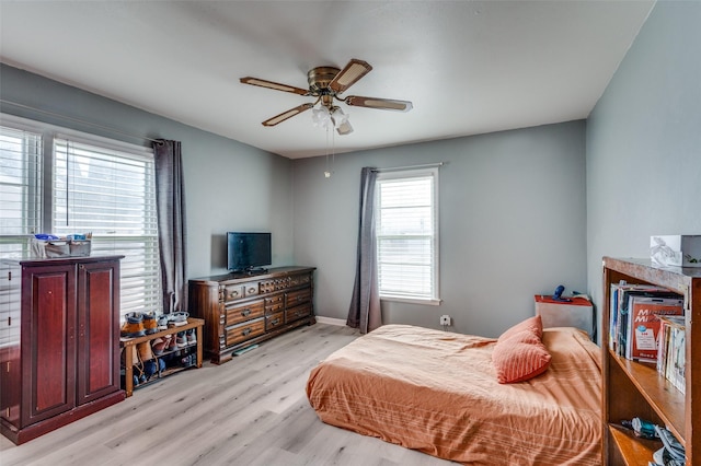 bedroom featuring light hardwood / wood-style floors and ceiling fan