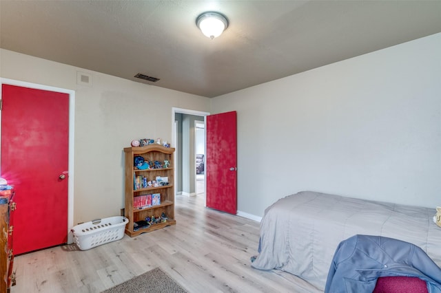 bedroom with light hardwood / wood-style flooring