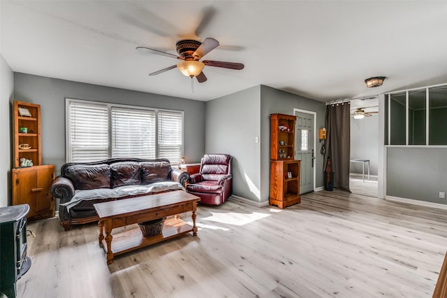 living room featuring ceiling fan and light hardwood / wood-style floors