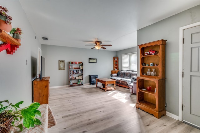 living room with ceiling fan and light wood-type flooring