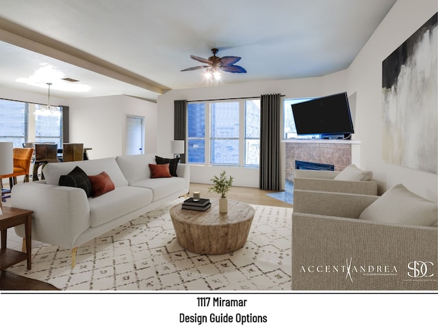 living room featuring a tile fireplace and ceiling fan