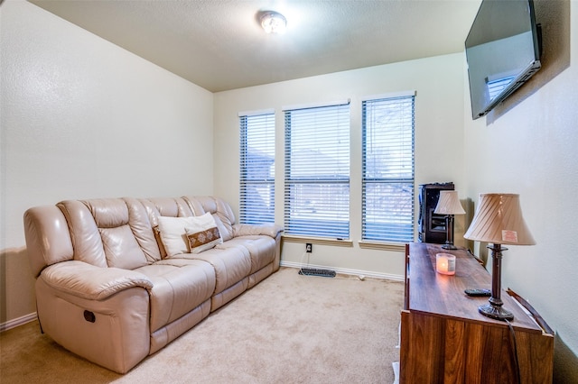 living room featuring a healthy amount of sunlight and light carpet