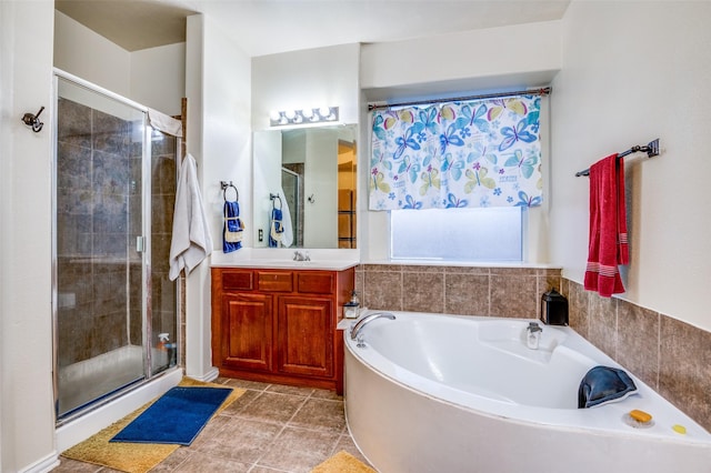 full bathroom featuring a shower stall, vanity, and a garden tub