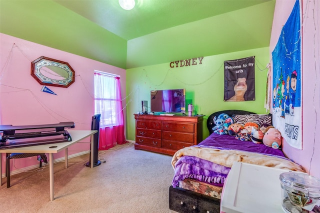 carpeted bedroom with baseboards and lofted ceiling