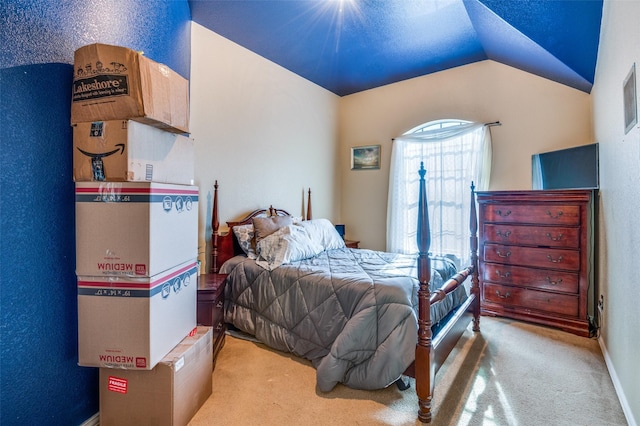 bedroom with carpet flooring and lofted ceiling