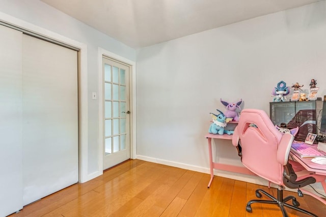 office area featuring baseboards and hardwood / wood-style floors