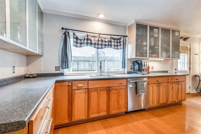 kitchen with crown molding, light hardwood / wood-style floors, dishwasher, and sink