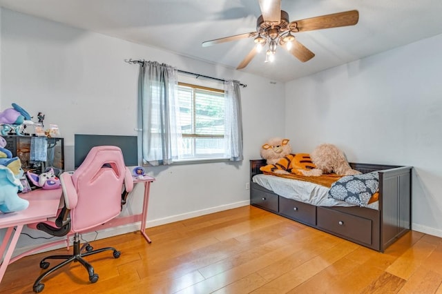 bedroom featuring baseboards, a ceiling fan, and wood finished floors
