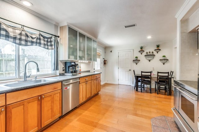 kitchen with visible vents, appliances with stainless steel finishes, a healthy amount of sunlight, and a sink