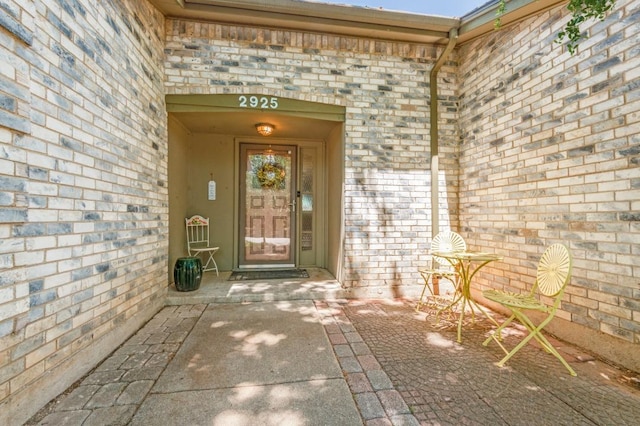 property entrance with brick siding