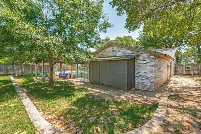 view of outbuilding featuring a fenced backyard and an outbuilding