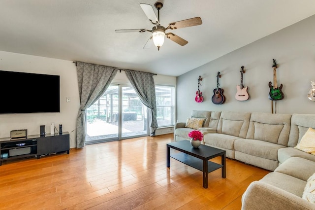 living room with light wood-style flooring and a ceiling fan