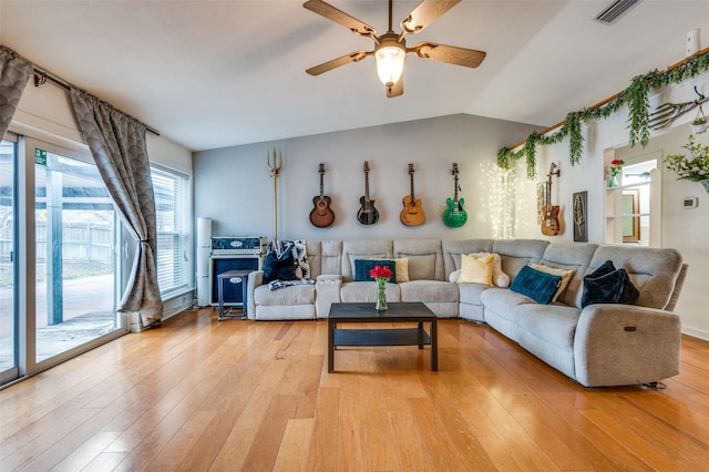 living room featuring vaulted ceiling, ceiling fan, and light wood-type flooring