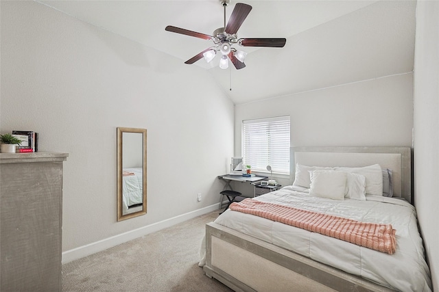 bedroom with ceiling fan, vaulted ceiling, and light carpet