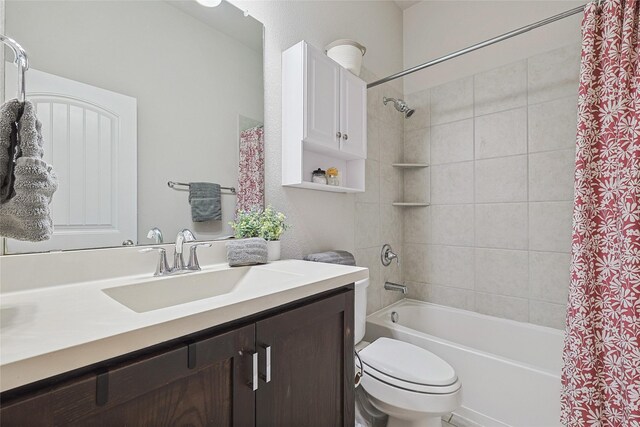 full bathroom with vanity, shower / bath combination with curtain, and toilet