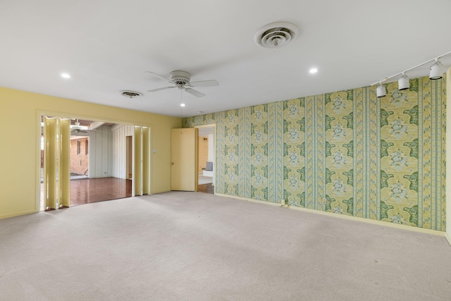 empty room with ceiling fan and carpet flooring