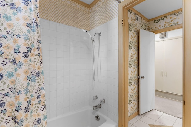 bathroom with crown molding, tiled shower / bath combo, and tile patterned floors