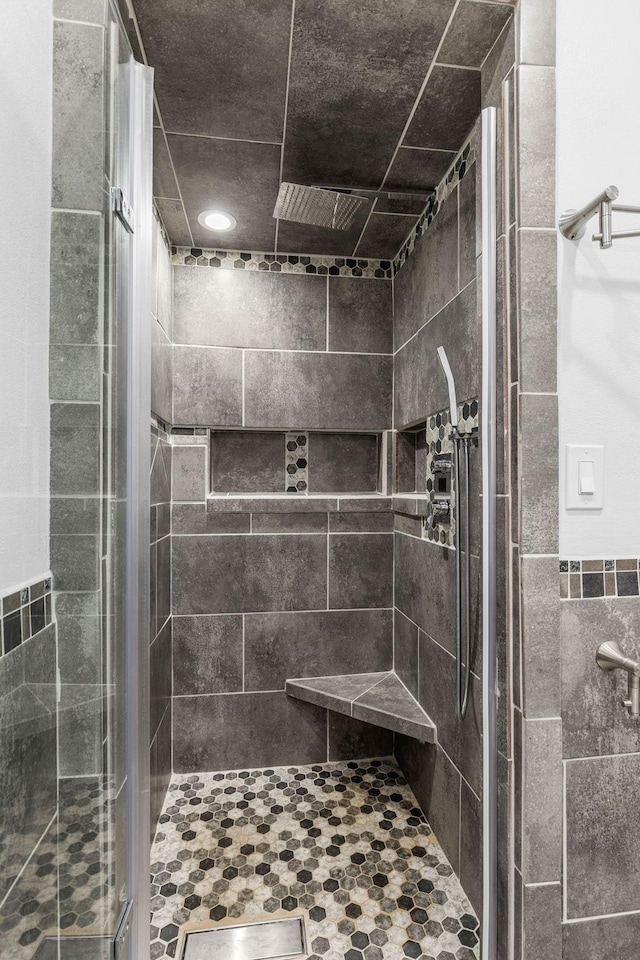 bathroom featuring a shower with door