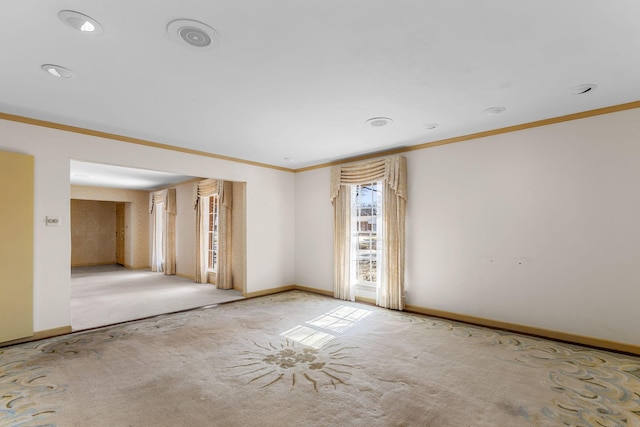 carpeted spare room featuring ornamental molding