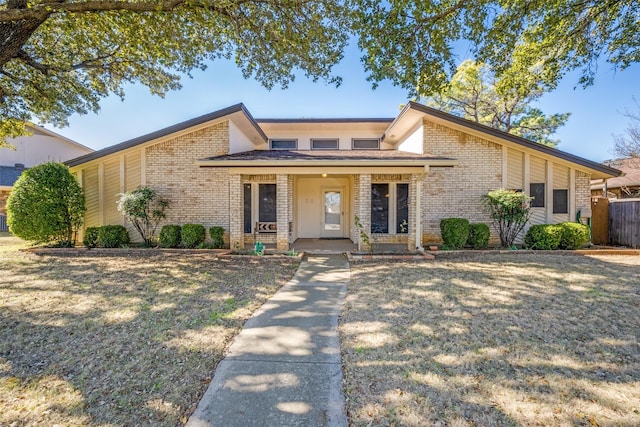 view of front of home with a porch and a front yard