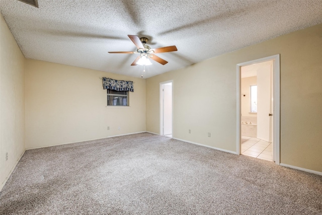 carpeted empty room with ceiling fan and a textured ceiling