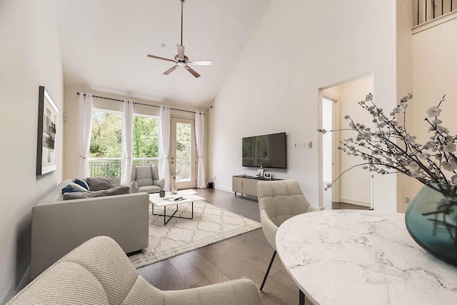 living room with ceiling fan, dark hardwood / wood-style flooring, and high vaulted ceiling